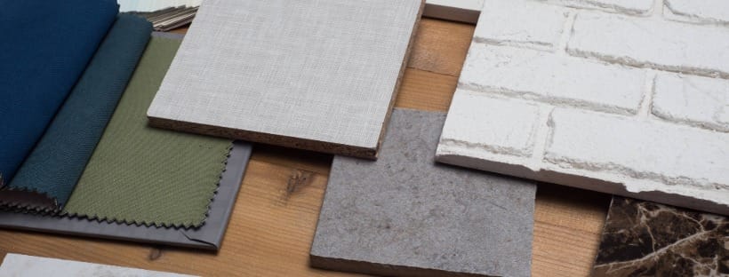 Home renovation material samples including fabric, tile, and wood laid out for planning updates