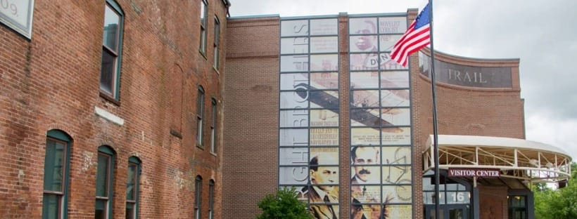 Exterior of the Dayton Aviation Heritage National Historical Park Visitor Center with large mural and American flag.